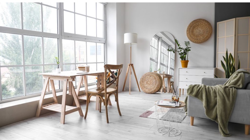 Cosy sofa with big windows and wooden table